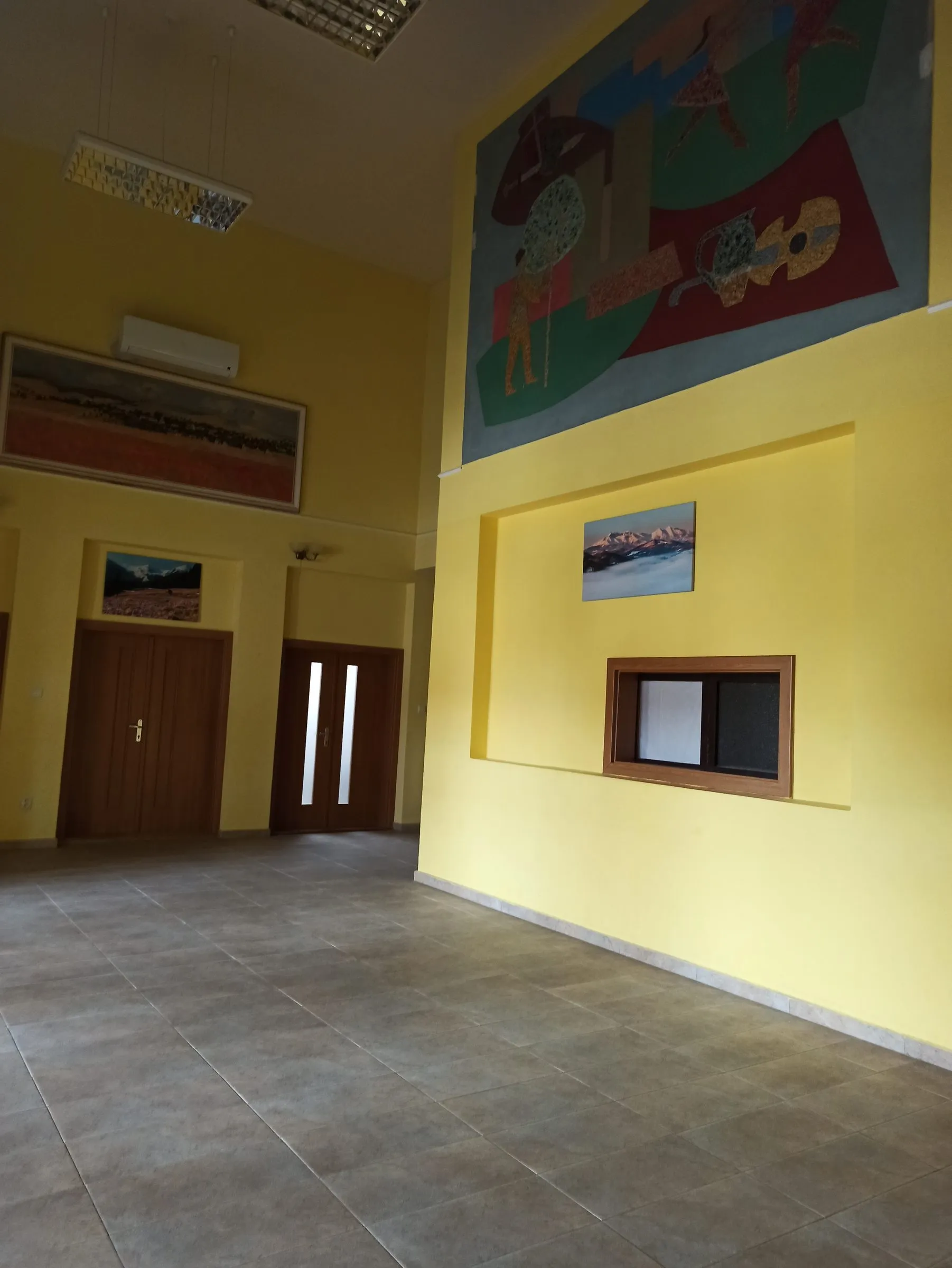 Pred: žltá stena s maľbou v sále